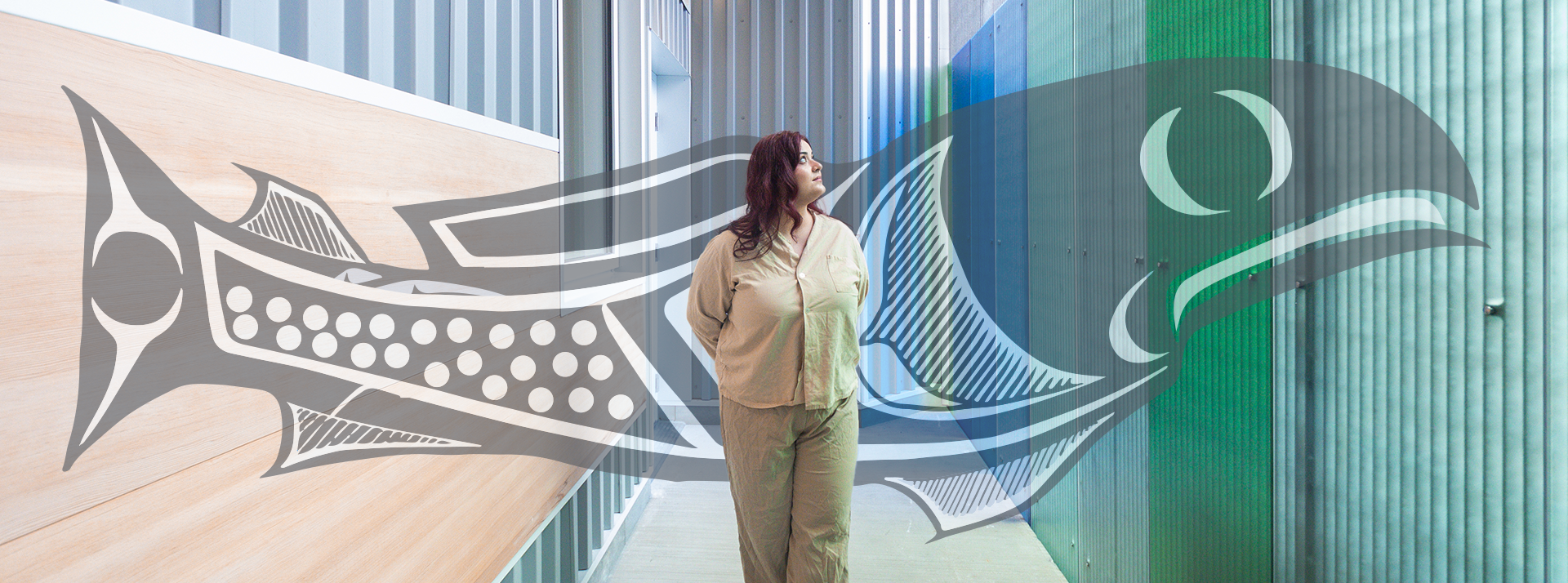 Person standing in hallway with illustration of a salmon behind them.