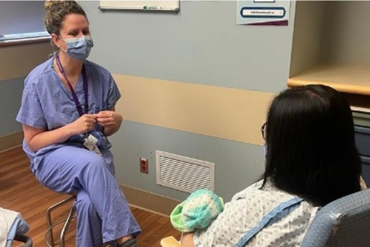 A lactation consultant meeting with a patient in a medical office room