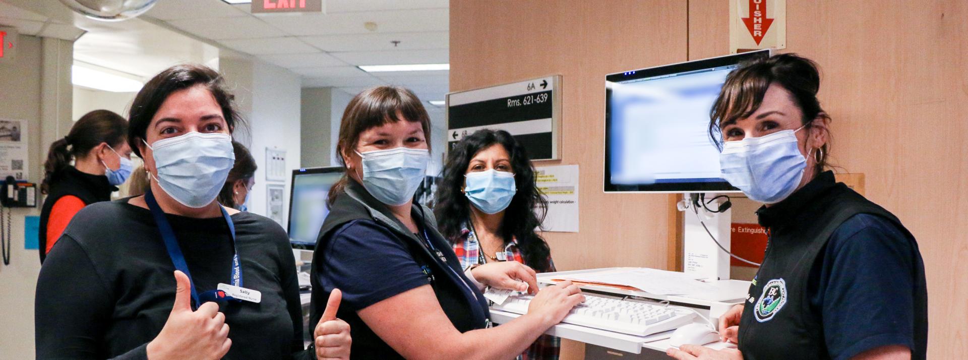 Group of VCH staff at computer.