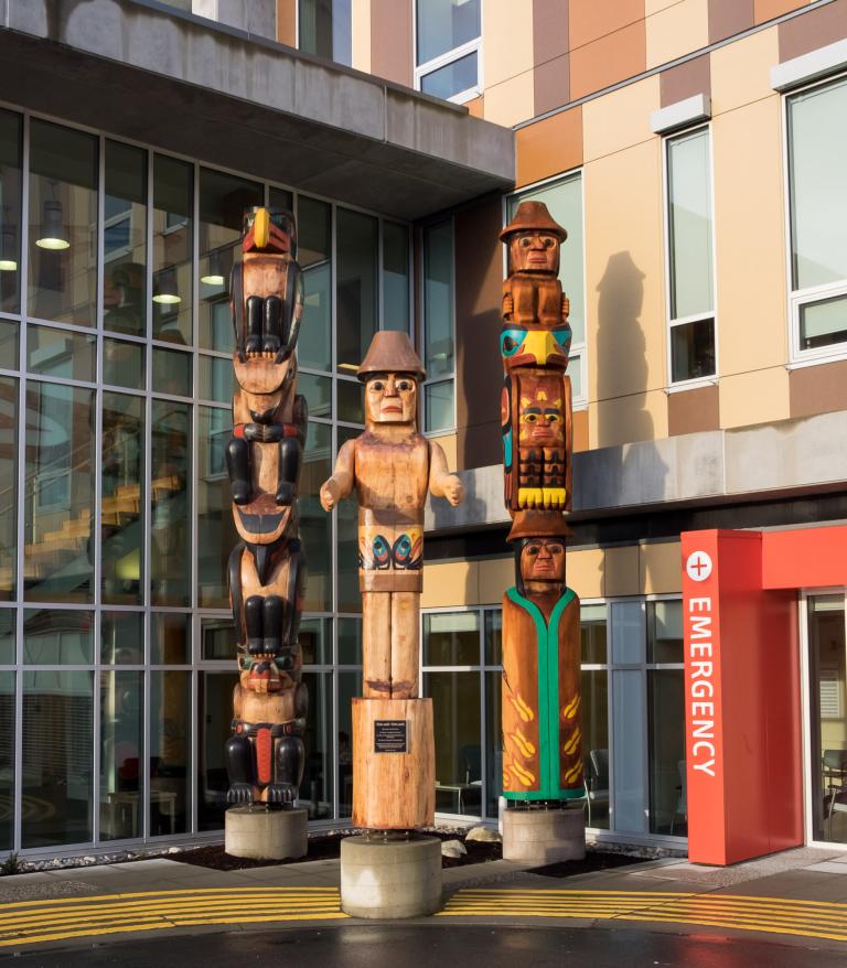 three totem poles outside the Sechelt shíshálh Hospital