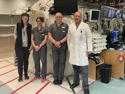 medical team standing in a medical room in from of a large hyperbaric chamber unit