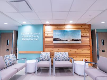 Hospital waiting area with chairs and a couch and a wooden slat wall